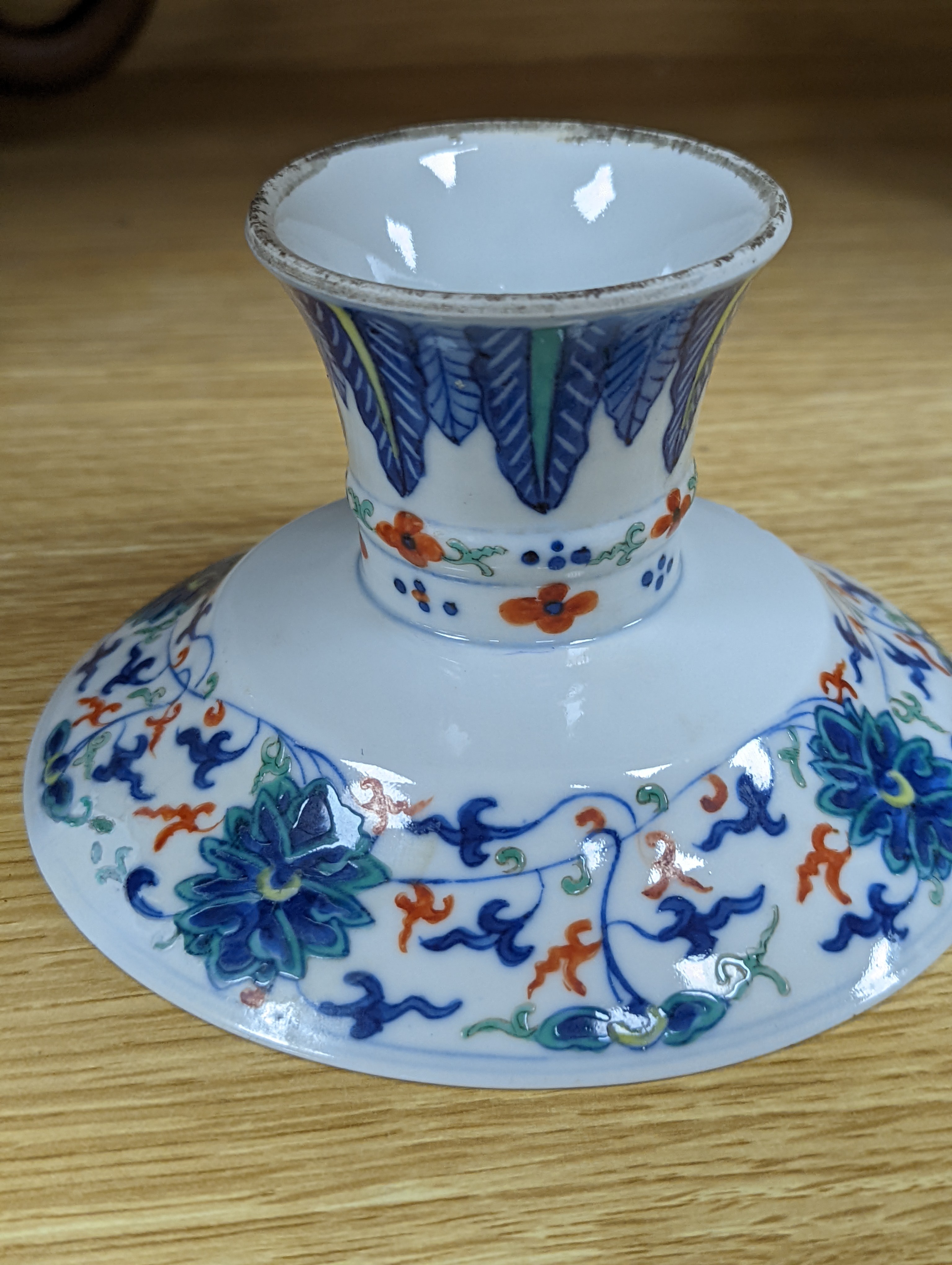 A Chinese blue and white water pipe vessel, a doucai stem dish and a Japanese Imari bowl, 19th century, (3)